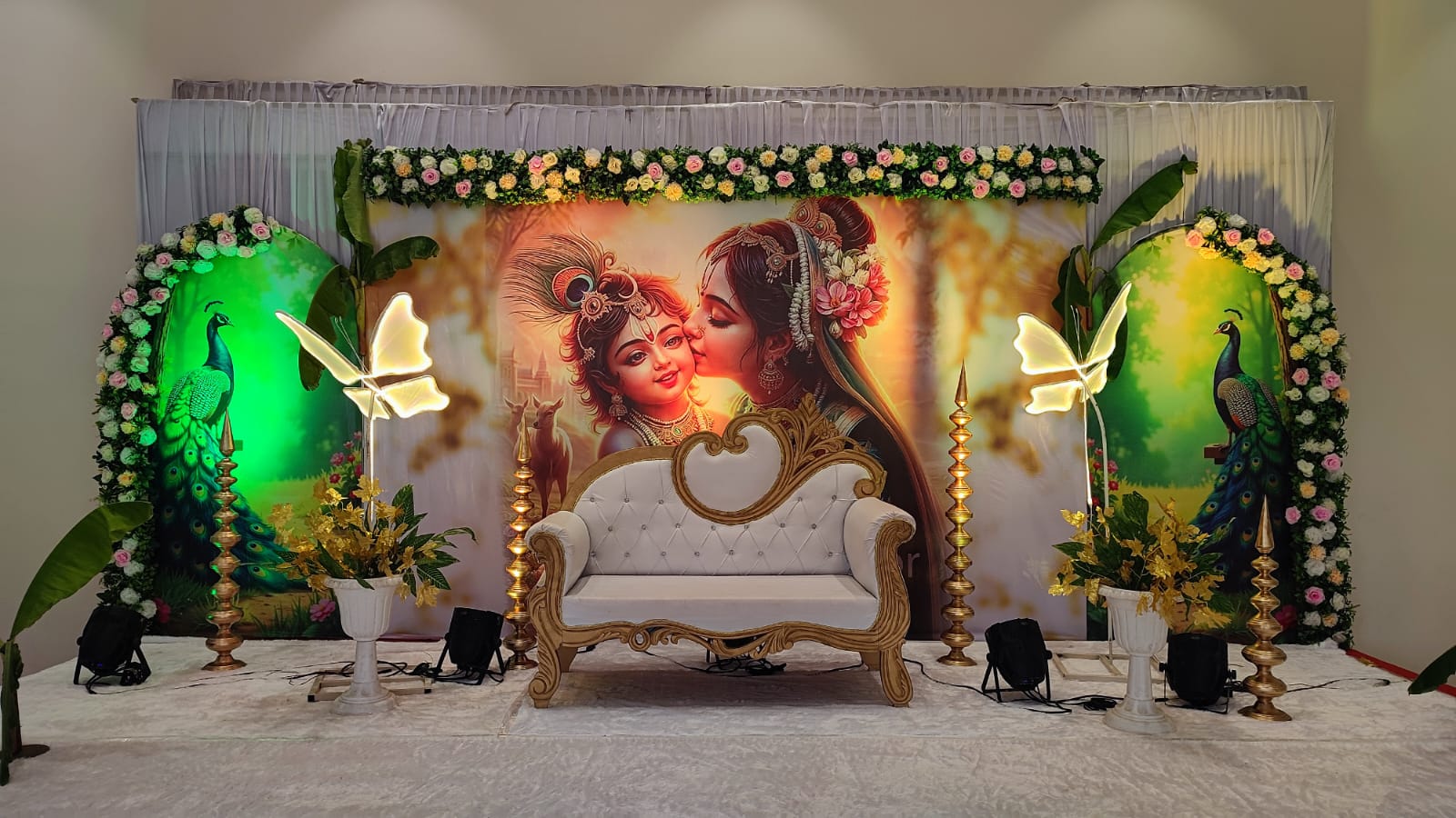 Baby shower backdrop with floral arches and lighting at Raj Rajeshwari AC Banquet Hall, Jule Solapur